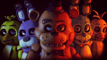 a group of five nights at freddy 's characters are lined up in a dark room