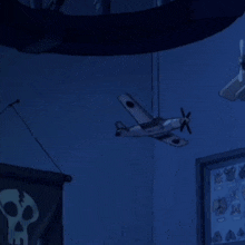 a cartoon character is hanging upside down with a skull and a plane in the background