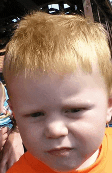 a close up of a child 's face with a serious look on his face