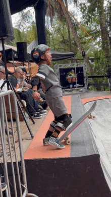 a young boy is riding a skateboard on a ramp with a pepsi sign in the background