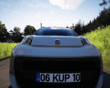 the front of a silver fiat car with a license plate that says 06 kup 10