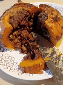 a slice of stuffed pumpkin is being taken out of it