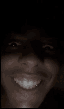 a close up of a person 's face with a smile