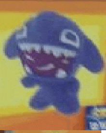 a blurry picture of a stuffed animal with a big mouth and teeth