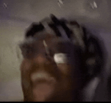 a blurry picture of a man wearing a helmet and goggles .