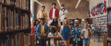 a group of children are posing for a picture in a library with a mural on the wall that says freedom