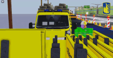 a yellow truck is driving down a road with a sign that says terminal 4 on it