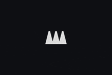 a white triangle on a black background with the letter m in the middle