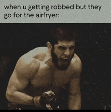 a shirtless fighter with a ufc logo on his glove