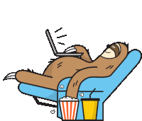 a sloth is laying in a chair using a laptop and eating popcorn