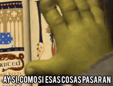 shrek 's hand is reaching out towards a book and saying `` ay si como si esas cosas pasaran '' .