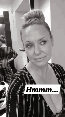 a black and white photo of a woman with a caption that says hmmm