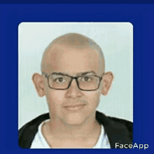 a picture of a man with glasses and a shaved head