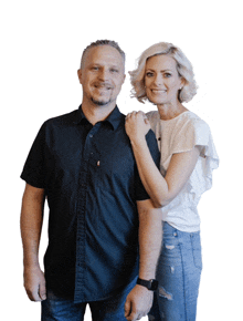 a man in a black shirt and a woman in a white top pose for a picture