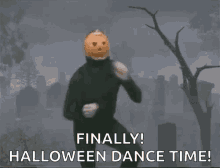 a man with a pumpkin on his head is dancing in a cemetery and says finally ! halloween dance time !