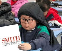 a young boy wearing glasses and a hood is holding a sign that says smith university