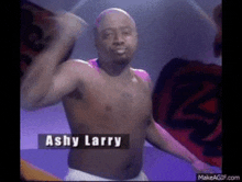 a shirtless man with the name ashy larry on the bottom of his chest