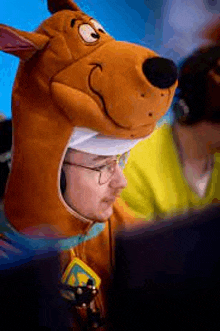 a man is wearing a scooby doo costume and glasses .