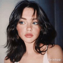 a close up of a woman 's face with faceapp written on the bottom right corner