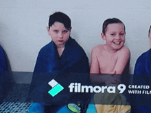 a group of young boys are wrapped in blue blankets and smiling in front of a filmora 9 logo