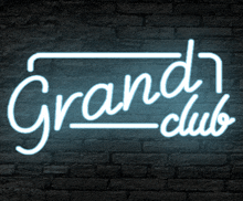 a neon sign that reads grand club on a brick wall