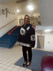 a woman wearing a hockey jersey with the number 94