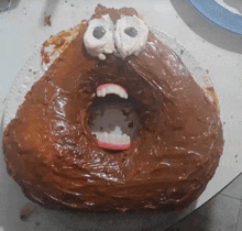 a cake that looks like a poop with a mouth open