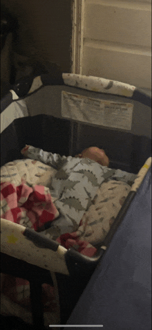 a baby is sleeping in a crib with a warning label on the side