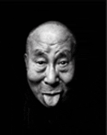 a black and white photo of a bald man with his tongue hanging out .