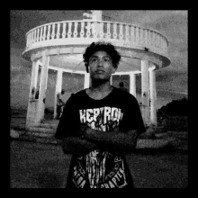 a black and white photo of a young man wearing a shirt that says keep ro