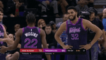 two basketball players wearing purple uniforms with the number 32 on the back