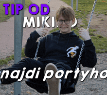 a man is sitting on a swing with the words tip od miki najdi portyho behind him