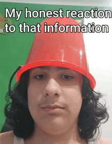 a young man wearing a red bucket on top of his head with the caption my honest reaction to that information