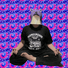 a person wearing a homegrown party bus tours shirt sits in a lotus position