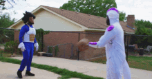 a man in a blue costume is holding a basketball while another man in a white costume is holding a basketball