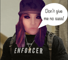 a woman wearing a black shirt that says the enforcer on it