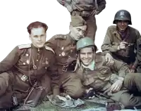 a group of soldiers posing for a picture with one wearing a helmet that says ' a '