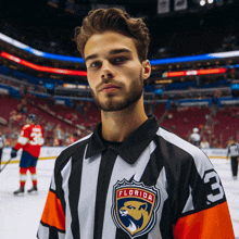 a man wearing a florida hockey jersey with the number 3 on the sleeve