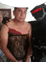 a man in a black lace top stands next to a man in a black mask