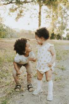 a boy and a girl are playing in the dirt