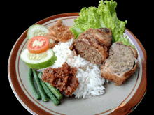 a plate of food with rice vegetables and meat