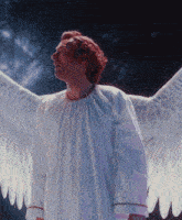 a man in a white robe with angel wings looks up at the sky