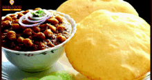 a bowl of chickpeas next to a plate of bread and a sign that says " indian food "