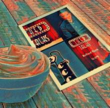 a framed picture of a man named richard stark sits on a wooden table next to a bowl of whipped cream