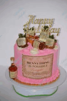 a pink birthday cake with bottles of liquor on top of it .