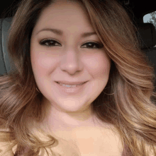 a woman with long brown hair is smiling for a picture