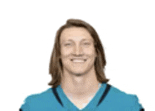 a man with long hair is wearing a blue football jersey .