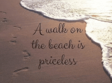 a walk on the beach is priceless is written on a sandy beach