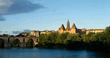 a bridge over a body of water in front of a city