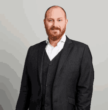 a man with a beard wearing a suit and vest